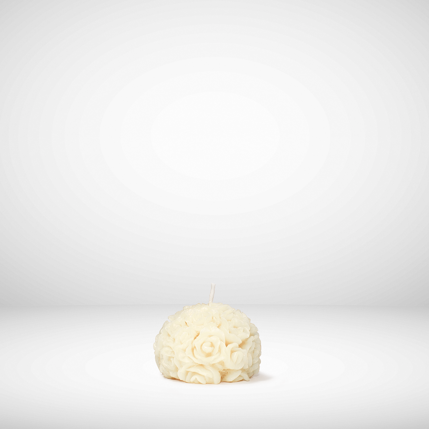 White floral beeswax candle on a white background