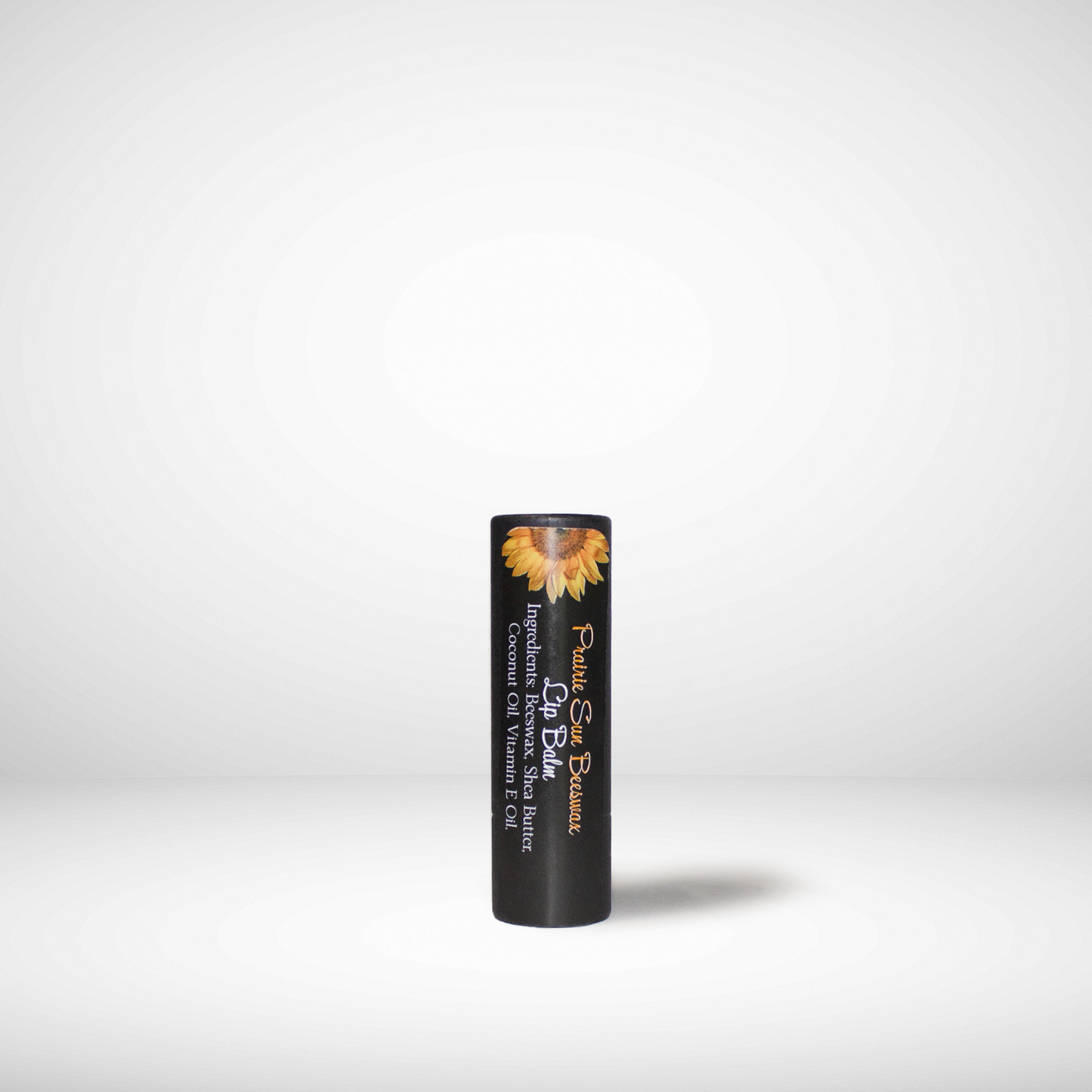 Black lip balm tube with a sunflower design on a white background