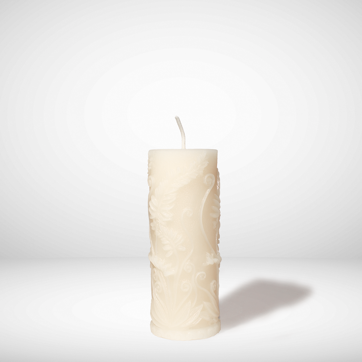 Textured white beeswax candle on a light gray background