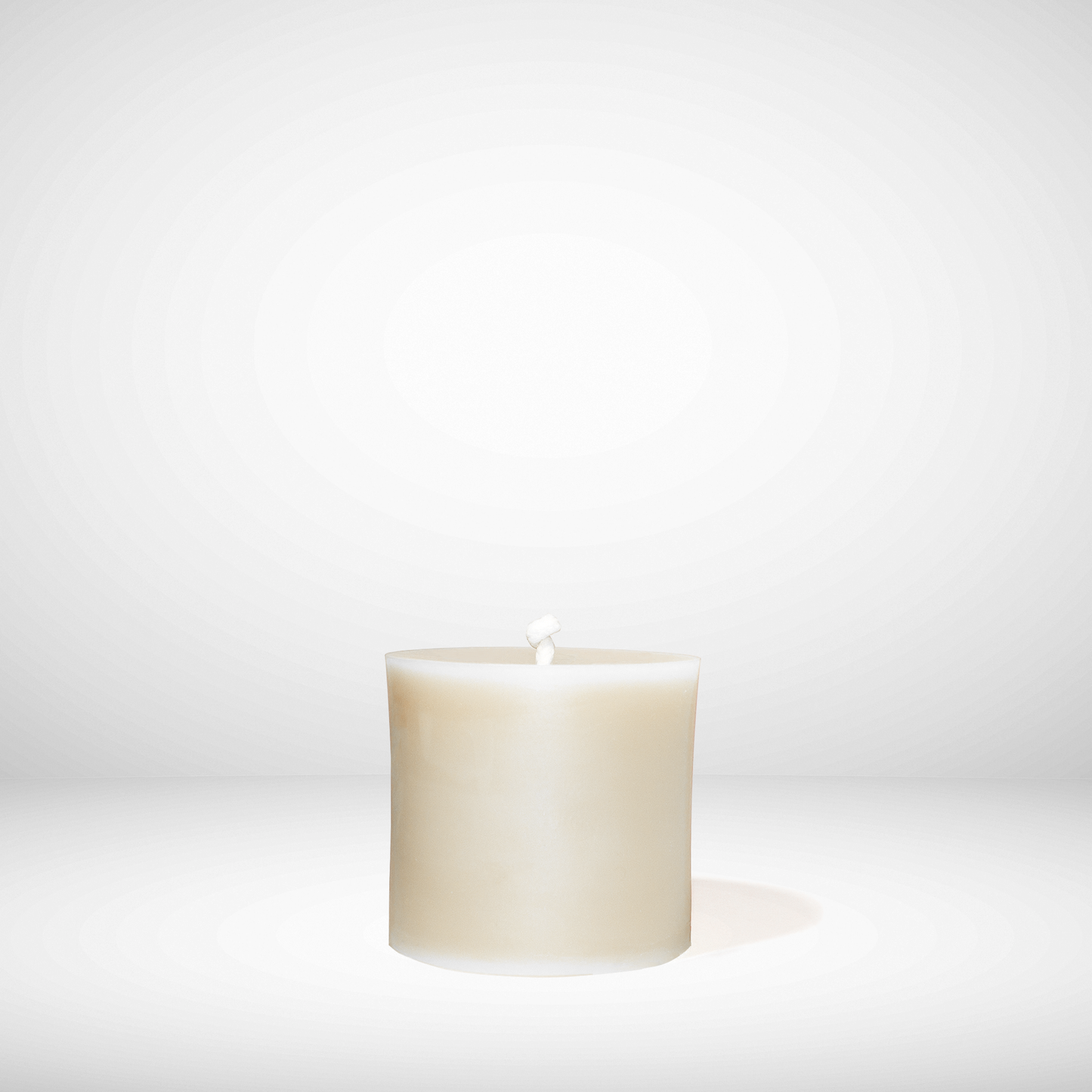 White beeswax candle on a white background