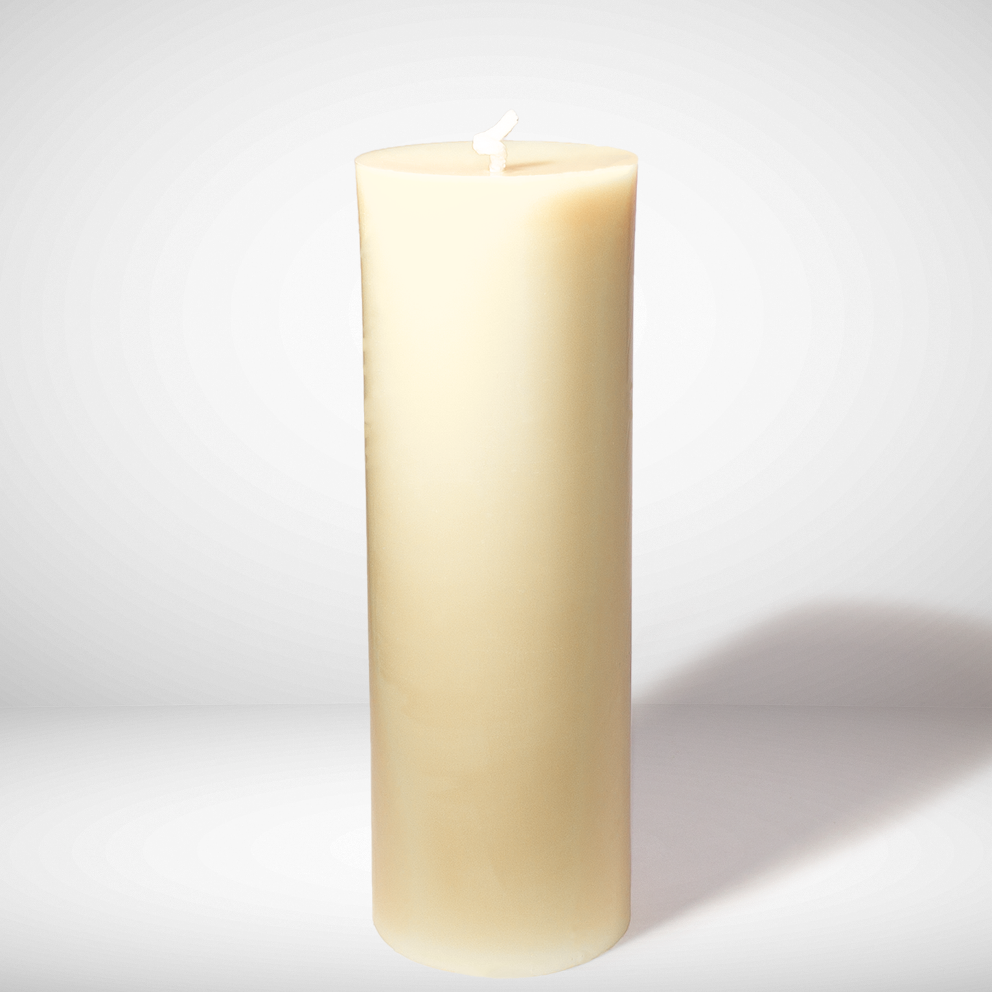 White beeswax candle on a white background