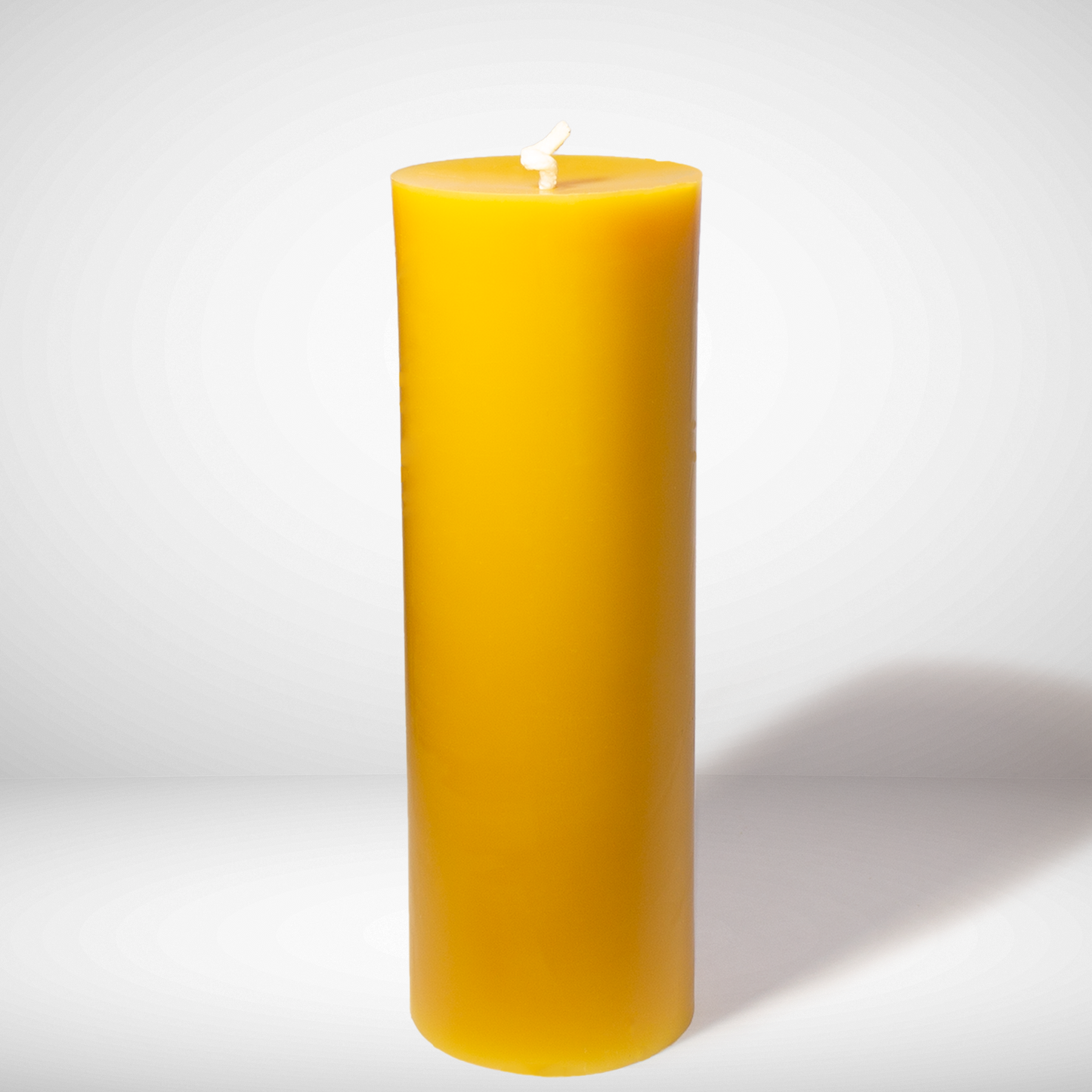 Yellow beeswax candle on a white background