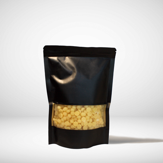 Black stand-up pouch with yellow contents on a white background