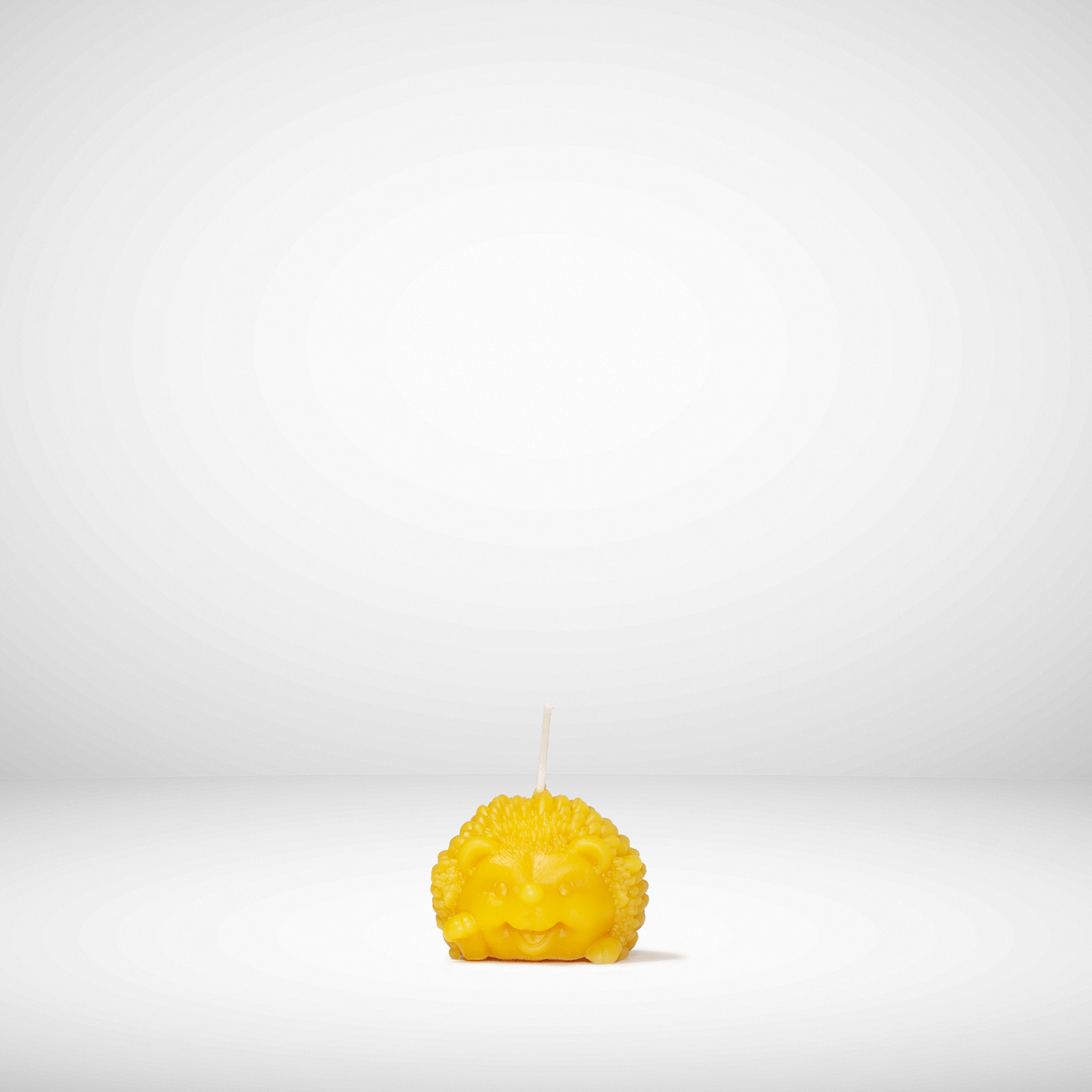 Yellow candle with a face on a white background