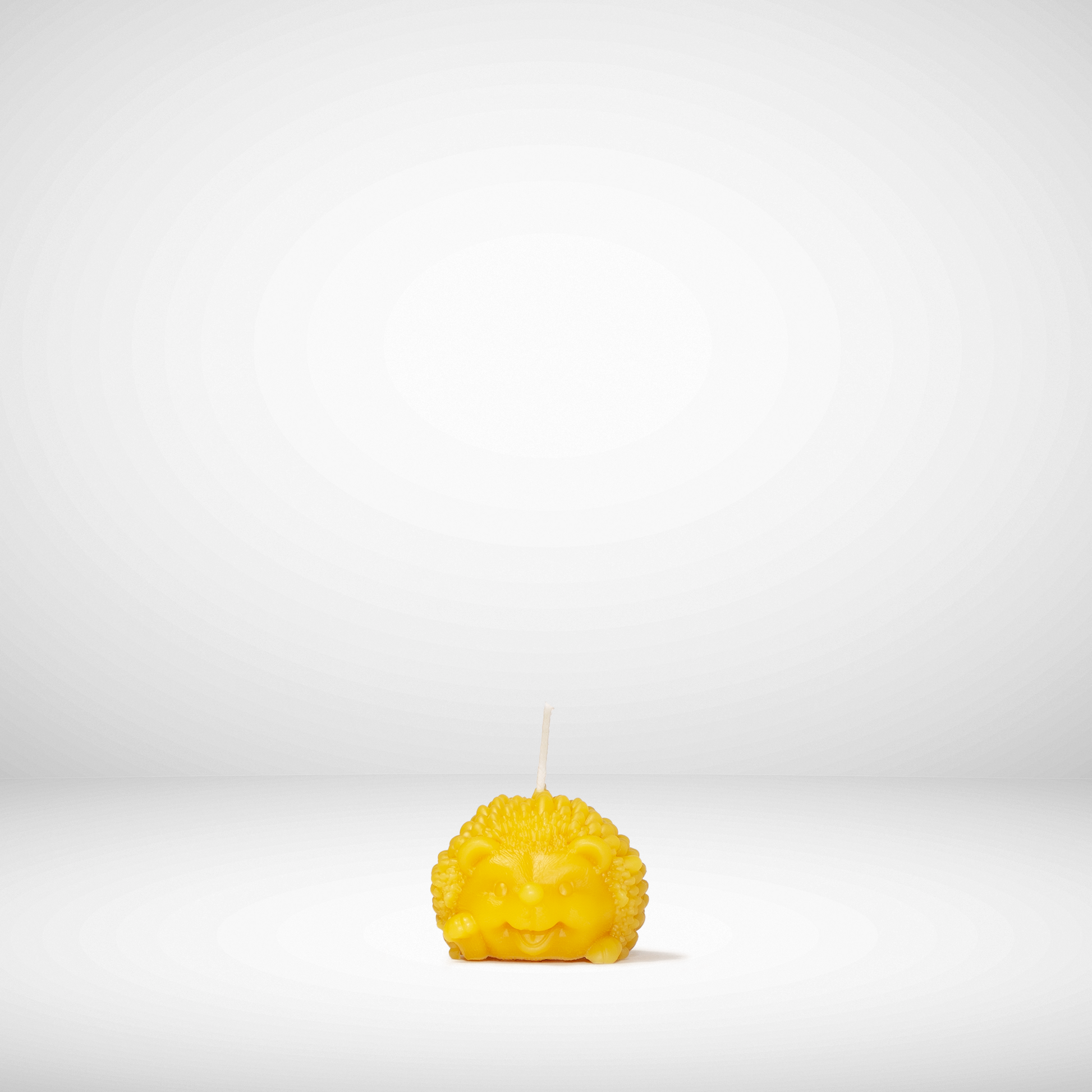 Yellow candle with a face on a white background