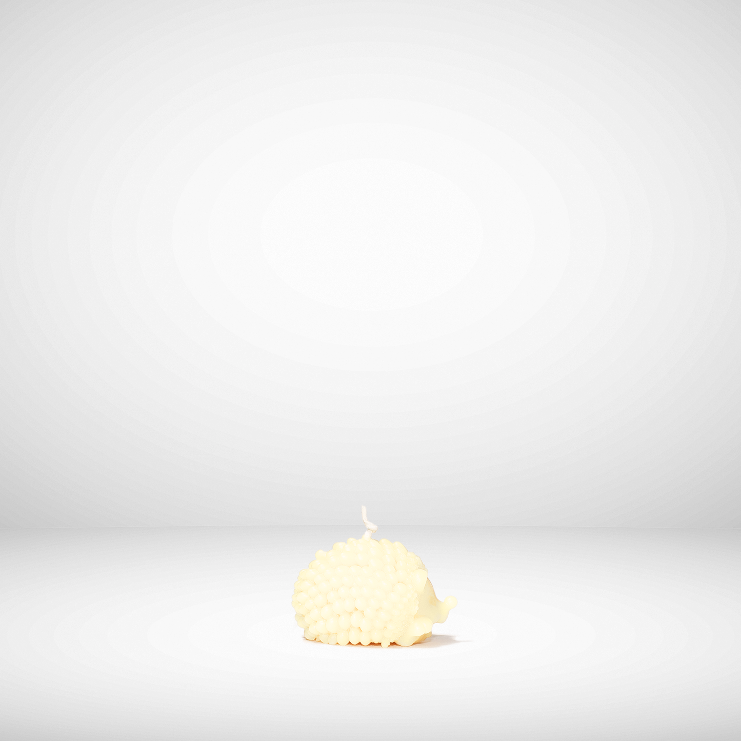 Single beeswax candle on a white background