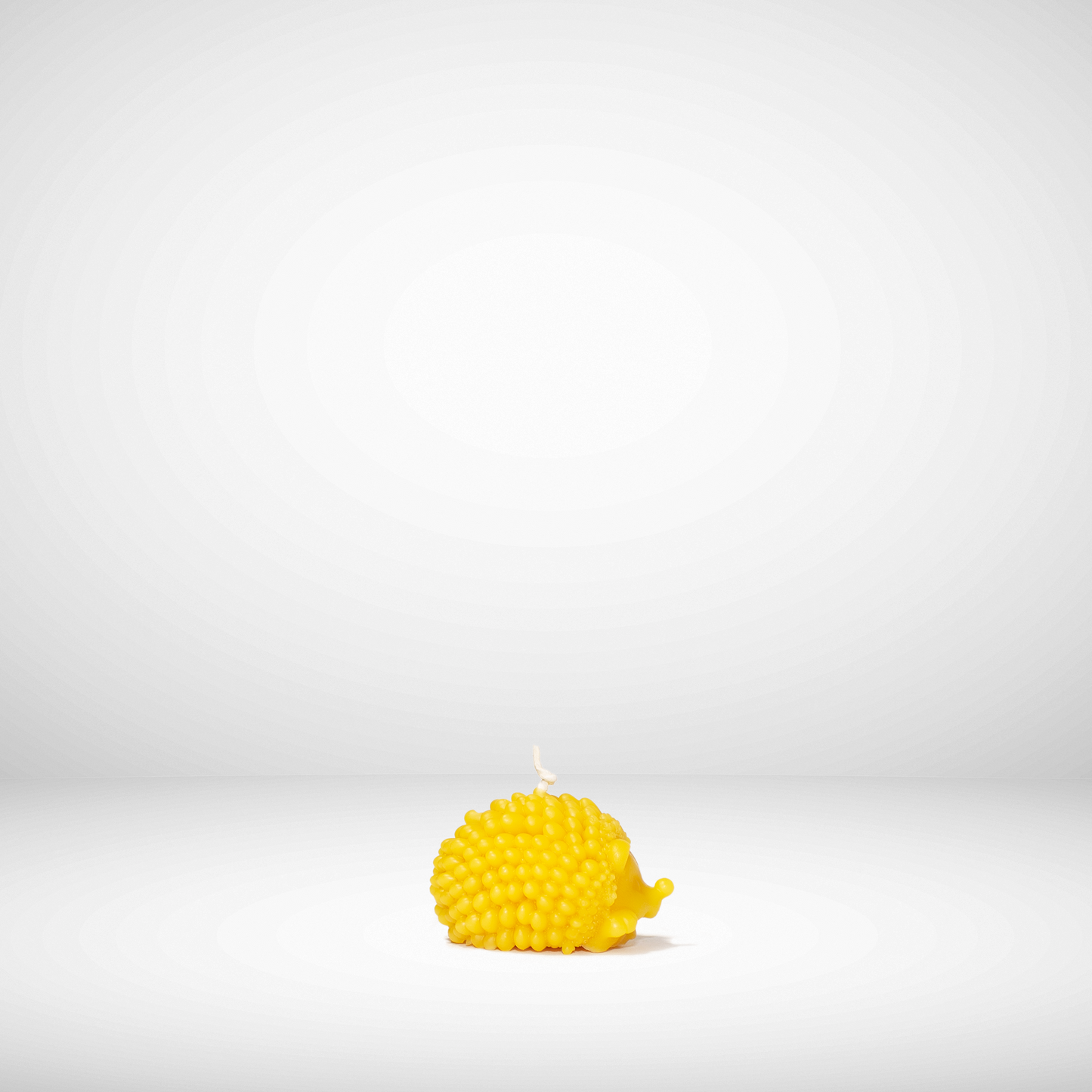 Yellow textured candle on a white background