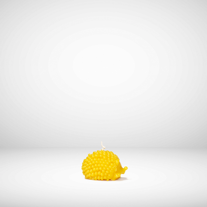 Yellow textured candle on a white background