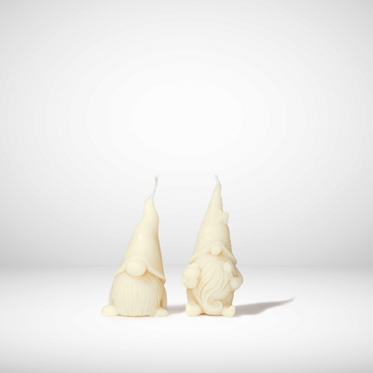 Two white beeswax gnome-shaped candles on a light gray background