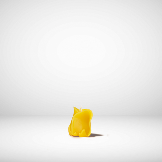 A solid yellow beeswax candle shaped like a rose, set against a white background