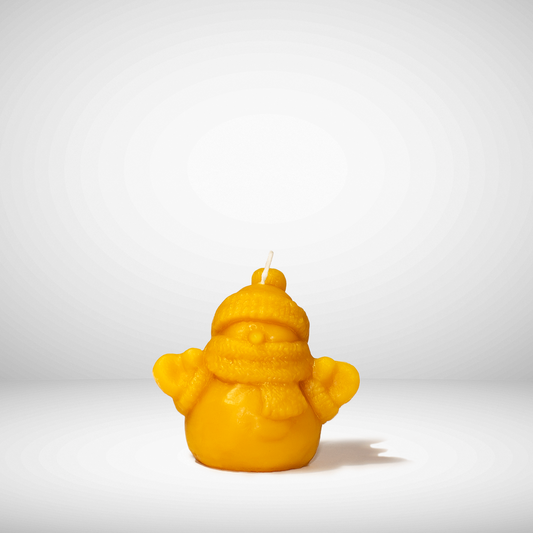 Yellow beeswax Candle that is  snowman with a hat and scarf