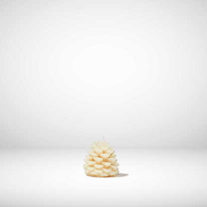 White pine cone-shaped beeswax candle on a white background