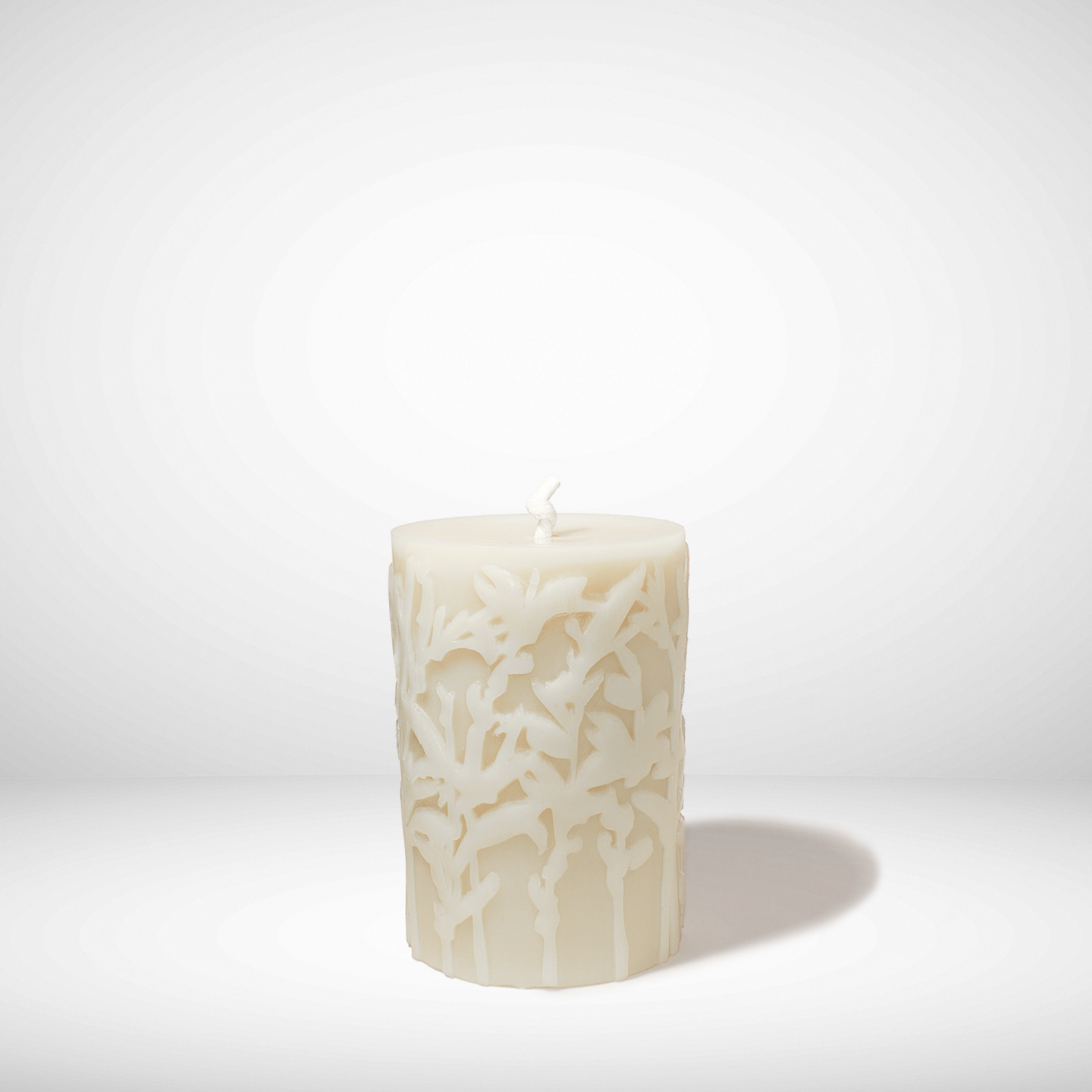 Decorative beeswax candle with a textured pattern on a white background